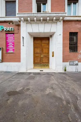a building with a large wooden door on a street at Vatican Guest House in Rome