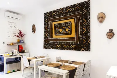 a room with tables and a tapestry on the wall at Magic Double in Rome