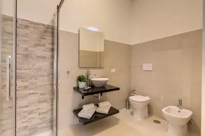 a bathroom with a toilet and a sink and a shower at YH SUITE 131 in Rome