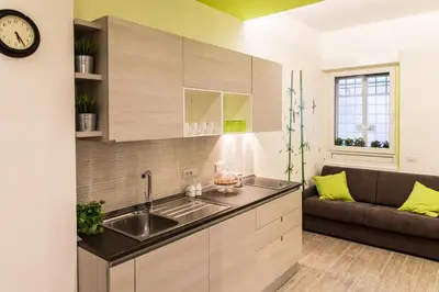 a kitchen with a sink and a couch at The Green Corner in Rome
