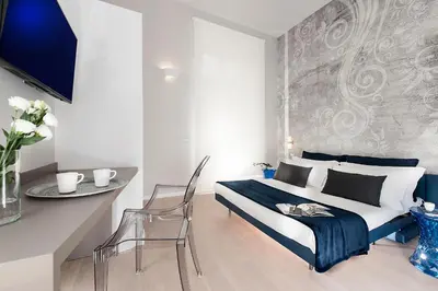 a bedroom with a bed and a table and a chair at Colosseum Corner in Rome