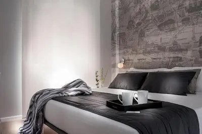a bedroom with a large bed with two candles on it at Colosseum Corner in Rome