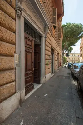 a building with wooden doors on the side of a street at Colosseum Corner in Rome