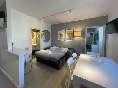 a small living room with a bed and a table at Vatican Holiday Apartment 317 in Rome