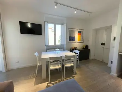 a dining room with a white table and chairs at Vatican Holiday Apartment 317 in Rome
