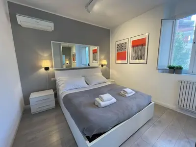 a bedroom with a large bed with two towels on it at Vatican Holiday Apartment 317 in Rome