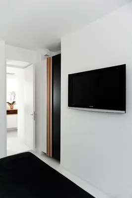a living room with a flat screen tv on a wall at Sora Luxury Inn in Rome