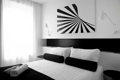 a black and white photo of a bedroom with a bed at Sora Luxury Inn in Rome