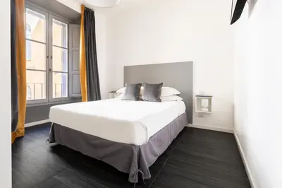 a bedroom with a large white bed and a window at Residenza Ottaviano 105 by Hili in Rome