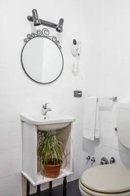 a white bathroom with a sink and a mirror at Sarah's House - Tourist Accommodation in Rome