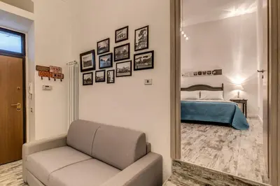 a living room with a couch and a bedroom at Loft in San Pietro in Rome