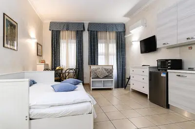 a small room with two beds and a kitchen at Apartment Julia Guesthouse Trevi - Spagna in Rome
