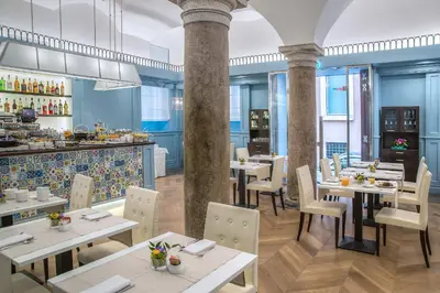 a restaurant with tables and chairs and a bar at Hotel Martis Palace in Rome