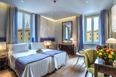 a hotel room with a bed and a table and chairs at Hotel Martis Palace in Rome
