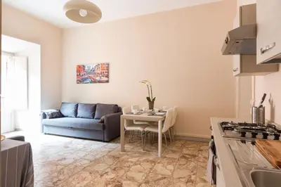 a living room with a couch and a table at G-House Pettinari in Rome