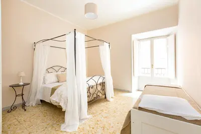 a bedroom with a bed with a canopy at G-House Pettinari in Rome