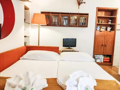 a bedroom with two beds and a television at Navona Stay Apartment in Rome