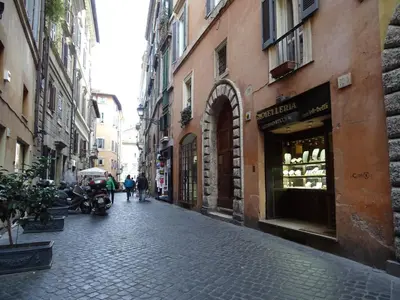 a cobblestone street in a city with people walking at Navona Stay Apartment in Rome