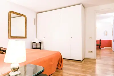 a bedroom with a bed and a mirror and a table at Navona Stay Apartment in Rome