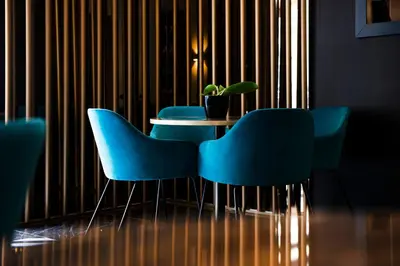 a table with blue chairs and a potted plant at Hotel 87 eighty-seven - Maison d'Art Collection in Rome