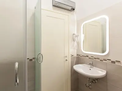 a bathroom with a sink and a mirror at Anice Guesthouse in Rome