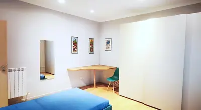 a bedroom with a blue bed and a desk at Casa Santarelli in Rome