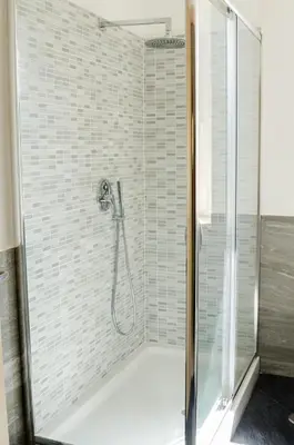 a bathroom with a shower with a glass door at Casa Santarelli in Rome