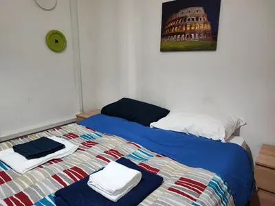 a bedroom with a bed with towels on it at Turati House in Rome