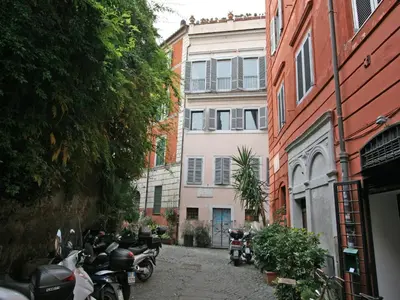 a group of motorcycles parked on a street next to buildings at Casa Leopardo - Trastevere in Rome