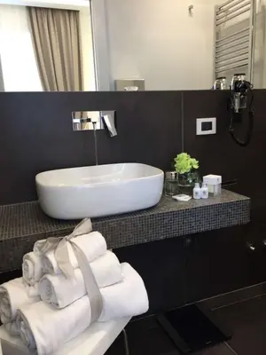 a bathroom with a white sink and towels on a counter at Vatican Style in Rome