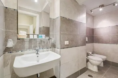 a bathroom with a sink and a toilet at Vaticano 38 Suites in Rome