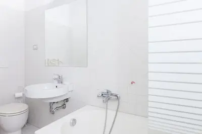a white bathroom with a sink and a toilet at La Maison de la vie in Rome