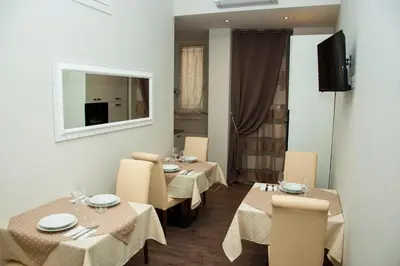 a restaurant with tables and chairs and a mirror at Holiday House Roma Vaticano in Rome