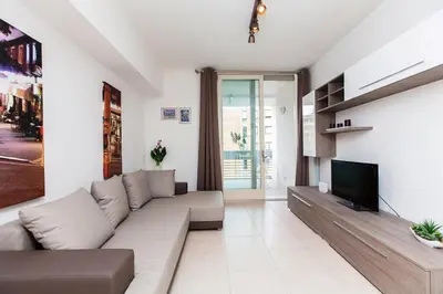 a living room with a couch and a tv at Boutique Domus in Rome