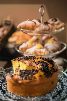 a bunch of donuts on plates on a table at Giuturna Boutique Hotel in Rome