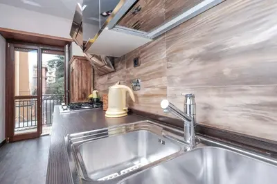 a kitchen with a stainless steel sink and a window at Monteverde 2BDR Family Apartment in Rome