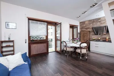 a living room with a table and a kitchen at Monteverde 2BDR Family Apartment in Rome