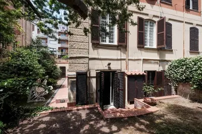 an old building with brown shutters on it at Villa Pamphili Classic Garden in Rome