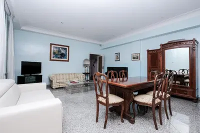 a living room with a wooden table and chairs at Villa Pamphili Classic Garden in Rome