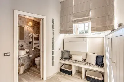 a small bathroom with a toilet and a sink at Vatican Sweet Home in Rome