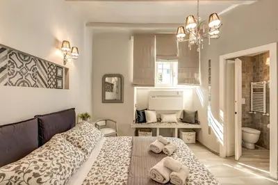 a bedroom with a bed with towels on it at Vatican Sweet Home in Rome