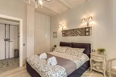 a bedroom with a large bed with two pillows at Vatican Sweet Home in Rome