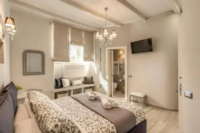 a bedroom with a bed and a television in it at Vatican Sweet Home in Rome
