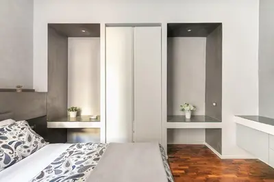 a bedroom with a bed and two mirrors at Living RHome - Condotti Apartment in Rome