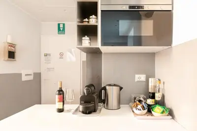 a kitchen with a counter top with a stove top oven at Living RHome - Condotti Apartment in Rome