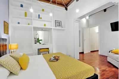 a living room with a bed and a couch at Laterano 238 Apartment in Rome