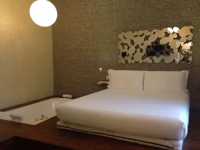 a bedroom with a bed and a bath tub at iRooms Central Station in Rome