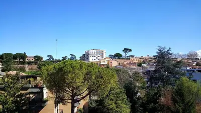 a view of a city with trees and buildings at St. Peter Station Suite in Rome