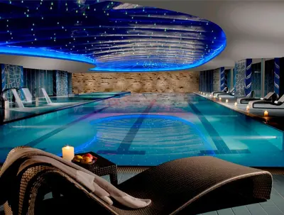 a swimming pool with a chair and a table at Parco dei Principi Grand Hotel & SPA in Rome