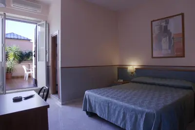 a hotel room with a bed and a balcony at Hotel Lazzari in Rome